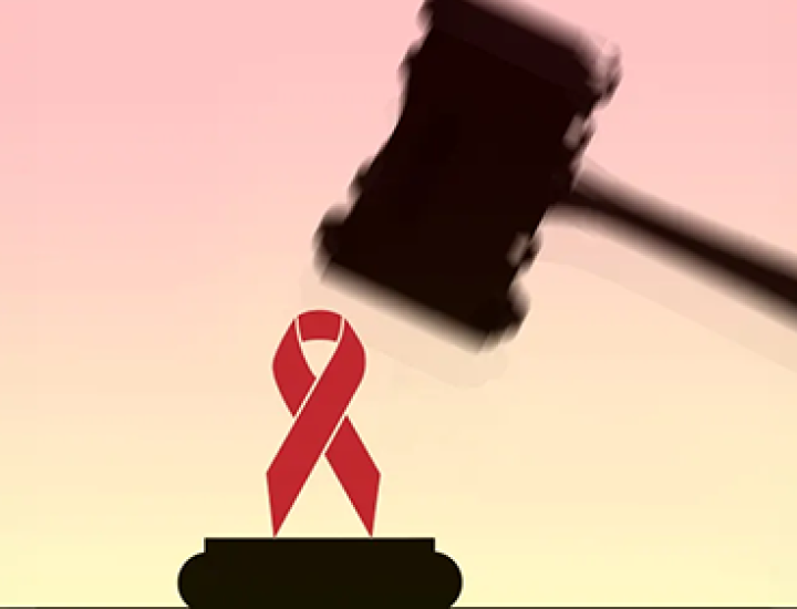 Stock image of legal gavel being lowered on a red AIDS ribbon.