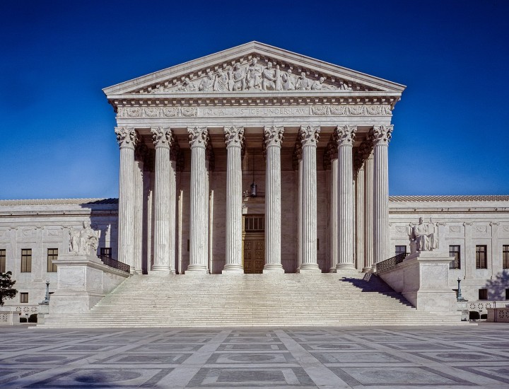Front of US Supreme court building against blue sky