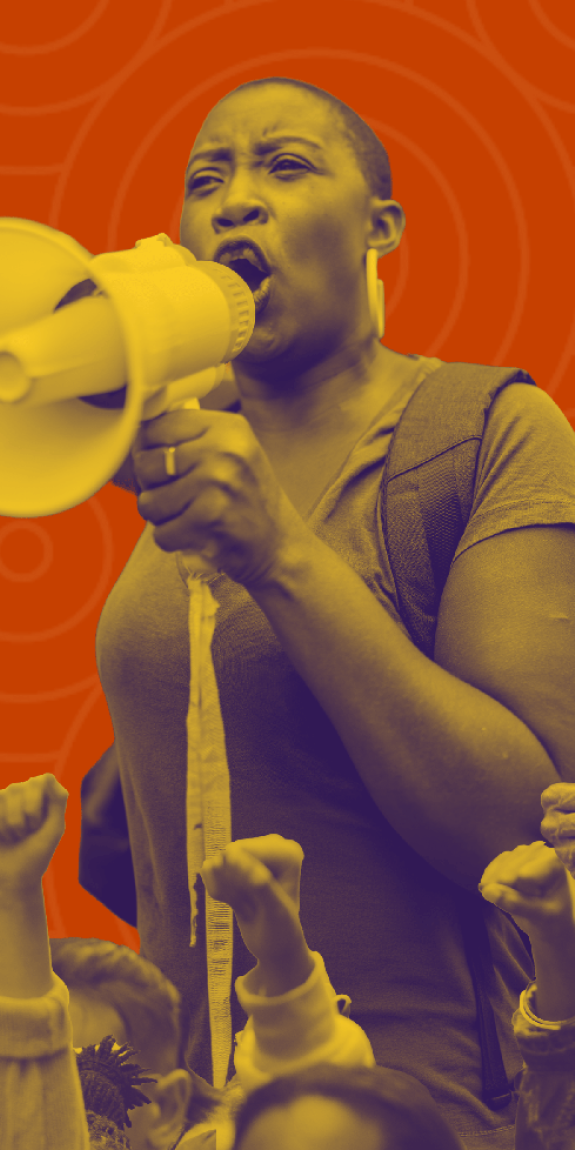 Defiant orange protest graphic shows a woman with a megaphone, raised fists, and signs reading “Liberty and Justice for ALL!” and “I AM NOT A CRIMINAL.”