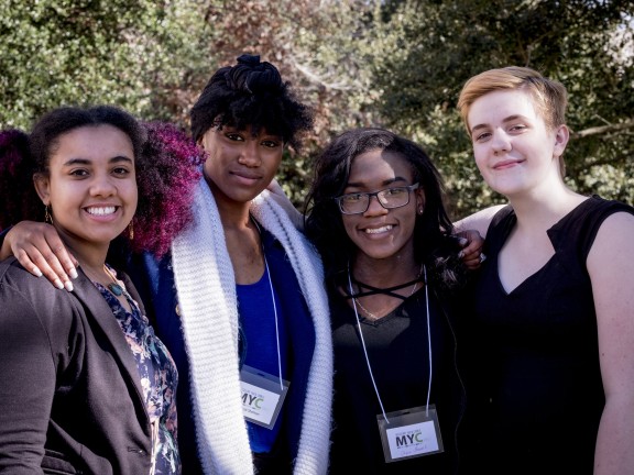 Four young women smiling