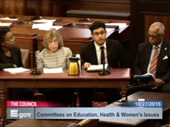 Screenshot of Four people at at desk for a Committee on Education Health and Women's Issues Meeting