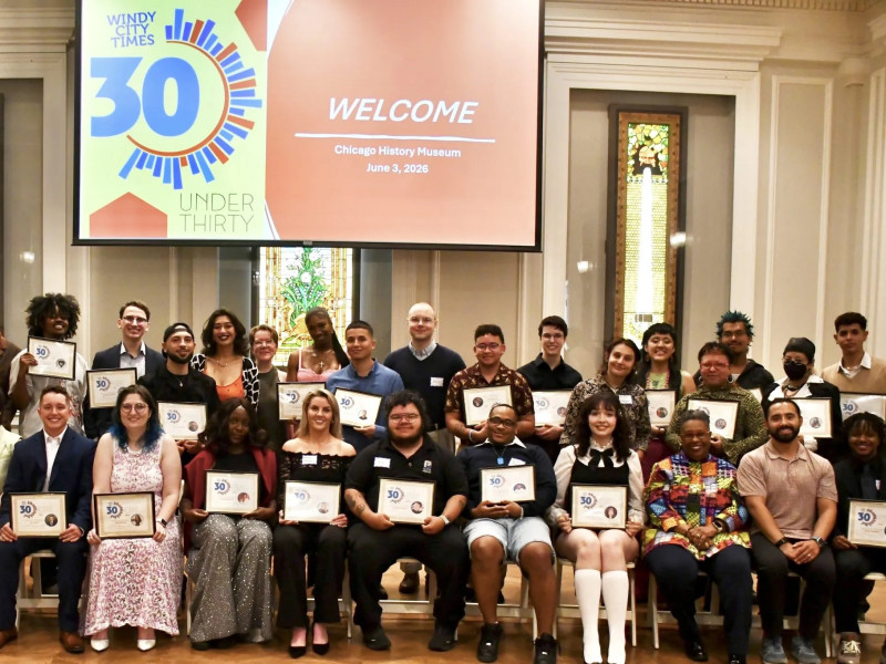 Group photo of 30 people holding certificates in a conference room