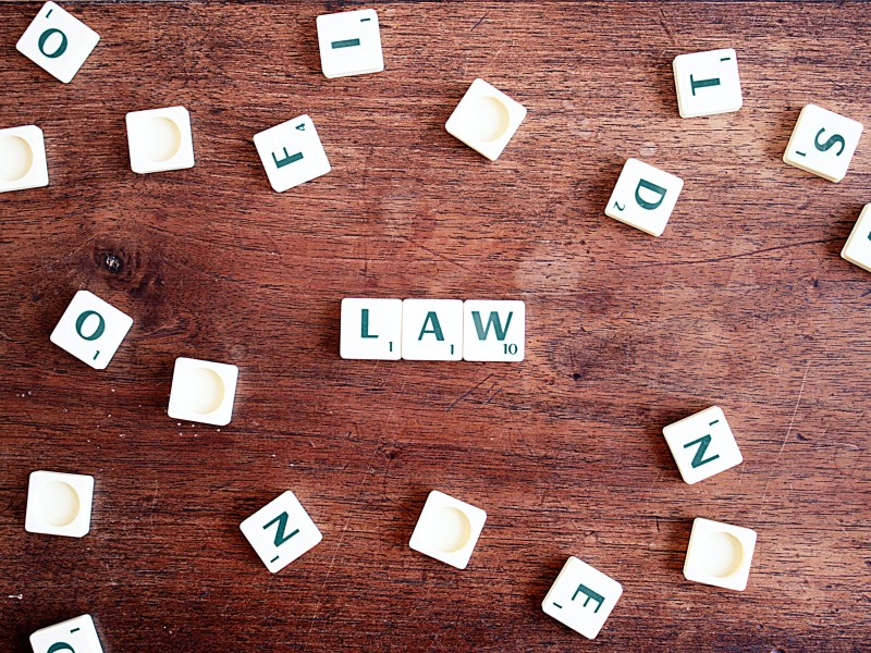 Photo of mock Scrabble game with the word law in the middle