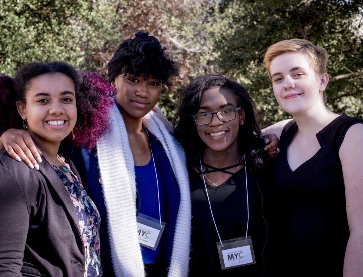 Four young women smiling