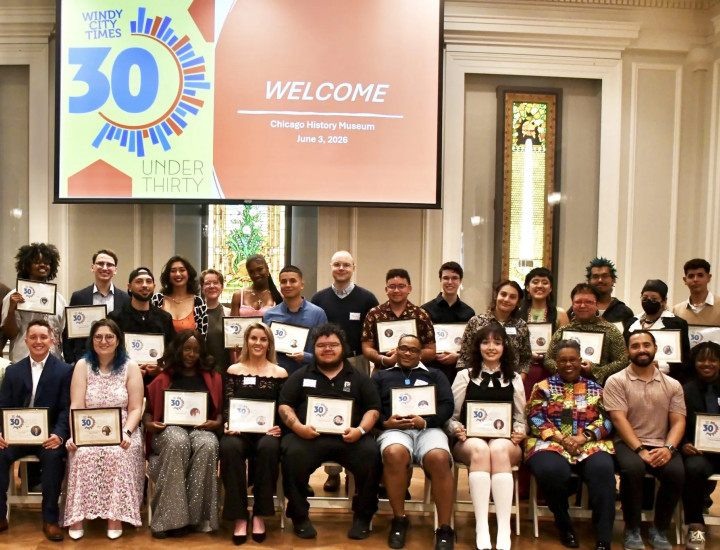 Group photo of 30 people holding certificates in a conference room
