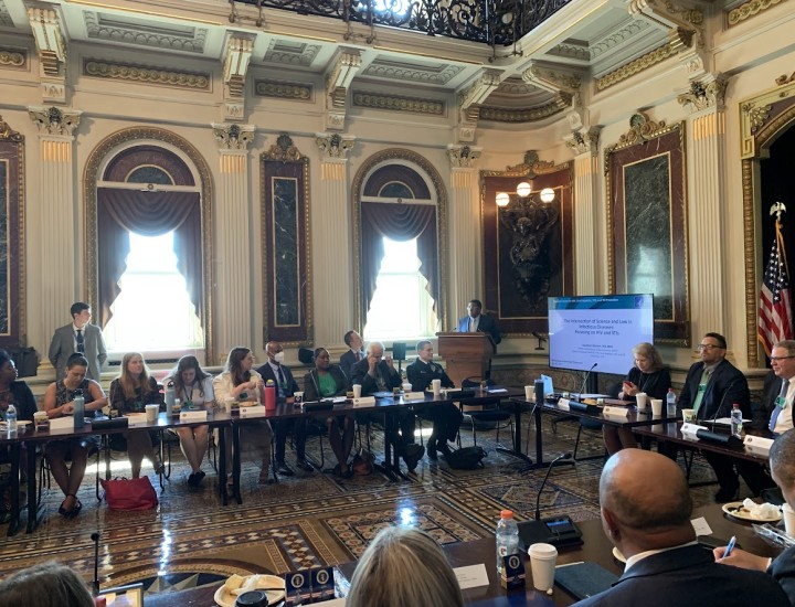 Interior of White House treaty room with  20+ people sitting around long tables