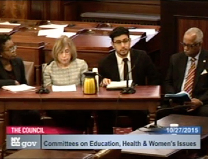 Screenshot of Four people at at desk for a Committee on Education Health and Women's Issues Meeting